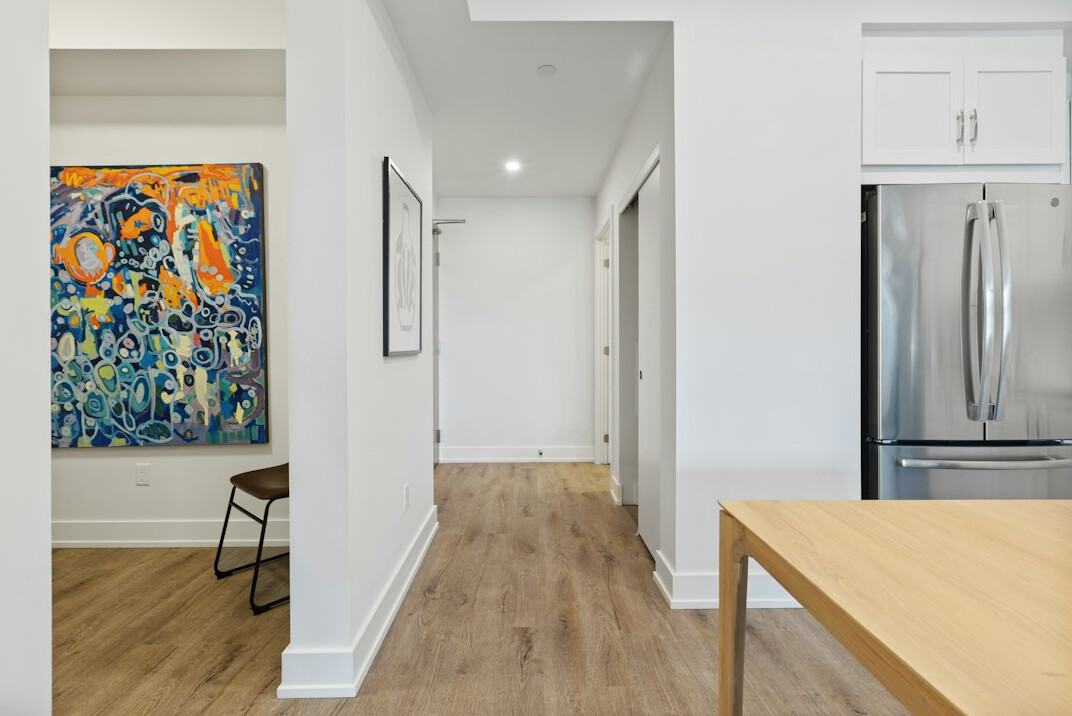 Employees walking through a modern renovated office hallway