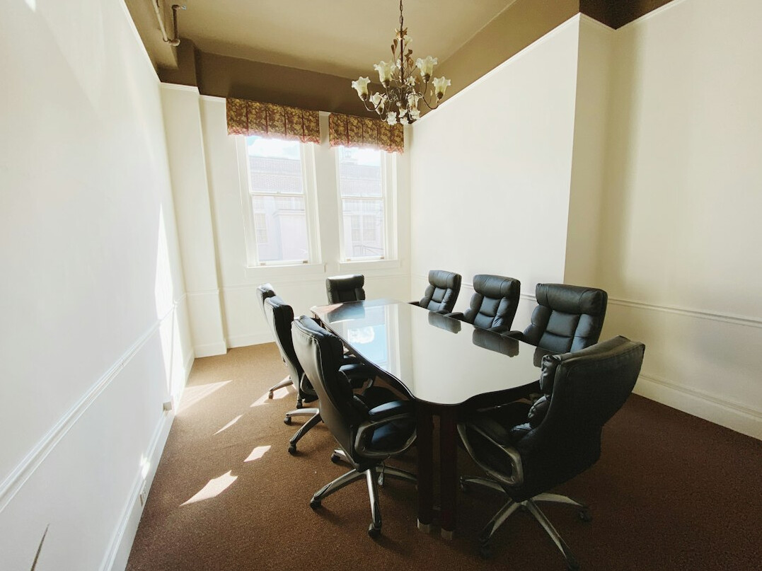 Consultants discussing office floor plans around a conference table